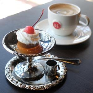 a dessert on a plate next to a cup of coffee at Hotel Kuu Kyoto in Kyoto