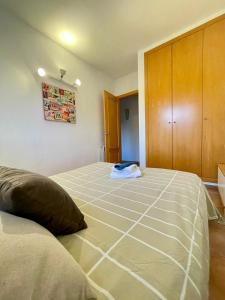a bedroom with two beds and a cabinet at Casa con piscina Sant Pol de Mar in San Pol de Mar