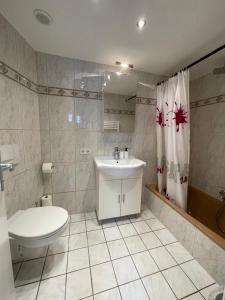 uma casa de banho branca com um WC e um lavatório em Apartment Violine1 am Bahnhof-City em Bayreuth