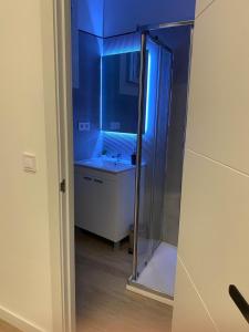 a bathroom with a glass shower and a sink at Suites Larios in Málaga