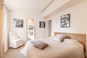 a bedroom with a large bed and a chair at Mas Oréa côté piscine in Gordes