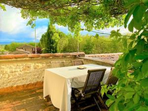 a table and two chairs sitting on a patio at Mas Oréa Sous la glycine in Gordes