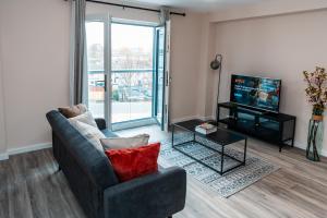 a living room with a couch and a television at Entire 2 Bedroom and 2 Bathroom Apartment in Manchester City -Free underground Parking in Manchester