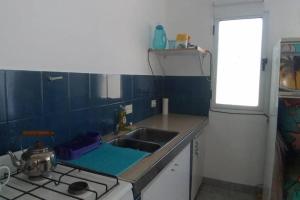 a kitchen with a sink and a stove at La verde de Playa in Playa Unión