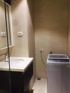 a bathroom with a sink and a counter with a stove at Tambuli maribago seaside living and resort in Lapu Lapu City