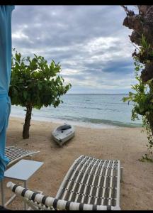 a mattress on the beach next to the ocean at Tambuli maribago seaside living and resort in Lapu Lapu City