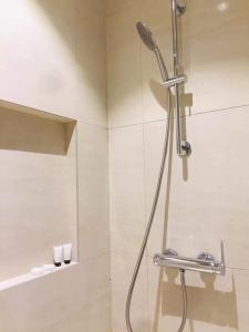 a shower with a shower head in a bathroom at Tambuli maribago seaside living and resort in Lapu Lapu City
