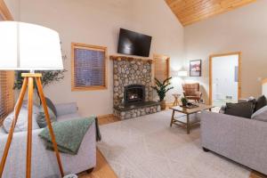 a living room with a couch and a fireplace at River Rock Chalet :: Hot Tub, Pets, Stevens Pass in Skykomish