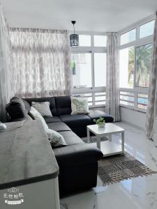 a living room with a couch and a table at San Eugenio in Adeje