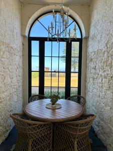 a dining room with a table and a large window at The Customs House Port MacDonnell in Port MacDonnell