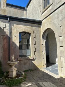 a building with a fountain in front of a window at The Customs House Port MacDonnell in Port MacDonnell