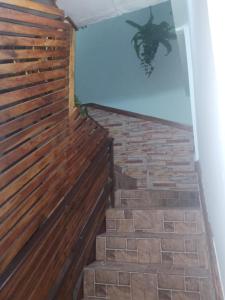 a staircase with a wooden fence and a brick wall at HOTEL EL CASTILLO MANTA2 in Manta