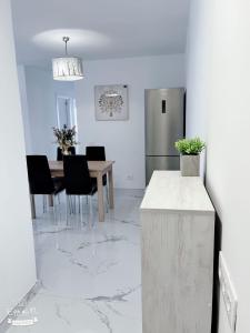 a kitchen and dining room with a table and a refrigerator at San Eugenio in Adeje