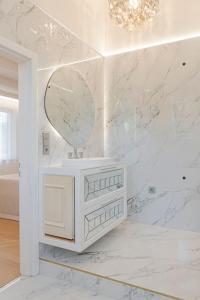 a white bathroom with a vanity and a mirror at 252 m² luxury 4 bedroom house in the pine-forest in Vilnius