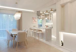 a kitchen and dining room with a table and chairs at 252 m² luxury 4 bedroom house in the pine-forest in Vilnius
