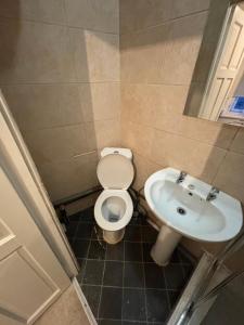 a bathroom with a toilet and a sink at Studios/ Bedsitter living unit -Ilford in Ilford