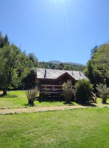 a cabin in the middle of a grassy field at Paso de los Troperos in La Junta