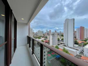 a balcony with a view of the city at Condomínio JSmart, localização ideal in Fortaleza