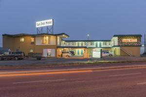 a building on the side of a street at night at Sun-Dek Motel in Medicine Hat