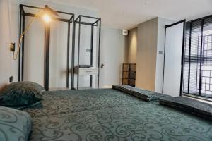 a bedroom with a large bed and a large window at Hash Silom Apartment @ Silom Soi 3 in Bangkok