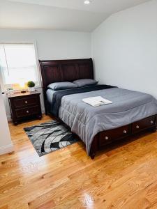 a bedroom with a bed and a table and a window at jfk 5 min away in Cedar Manor