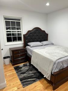 a bedroom with a bed and a window at jfk 5 min away in Cedar Manor