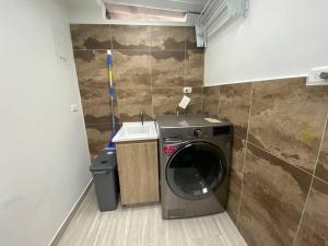 a washing machine in a bathroom with a sink at Alojamiento/Lodging:El Indio Ese in Sopo