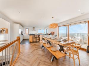 a dining room with a table and a kitchen at The Beaches in Berwick-Upon-Tweed