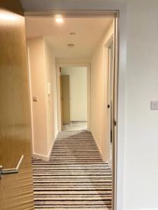 an empty hallway with a hallway leading into a room at Stylish Central Escape in Sheffield