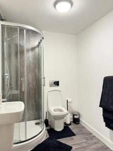 a bathroom with a shower and a toilet and a sink at Stylish Central Escape in Sheffield