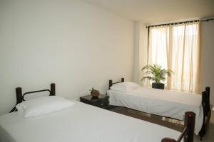 Rúm í herbergi á Guayacán Casa Hostal