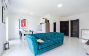 ein blaues Sofa im weißen Wohnzimmer in der Unterkunft Beautiful Apartment In Kastel Kambelovac With Jacuzzi in Kaštela