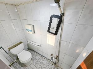 a bathroom with a toilet and a water hose at 8 Hotel in Seoul