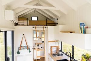 a room with a bunk bed in a tiny house at Tiny Madeline 