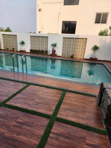 a swimming pool in the middle of a building at Manidweepa farm house in Venkatāpur