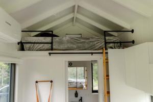 a room with a bunk bed in a tiny house at Tiny Nancy in Bellingen