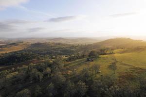 an aerial view of a valley with hills and trees at Tiny Charlie in Haden