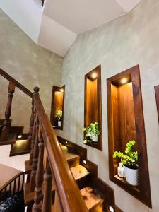 a staircase with potted plants on the walls at Matheera holiday home in Jaffna