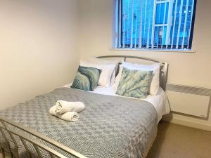 a bedroom with a bed with two towels on it at Manchester City Center Apartment in Manchester