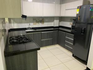 a kitchen with a stove and a refrigerator at Casa Quintanilla in Villanueva