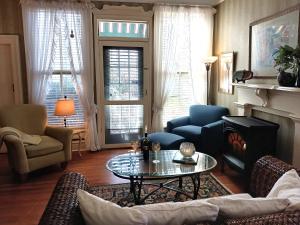 a living room with a couch and a table at Rosemont B&B Cottages in Little Rock