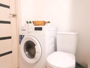 a bathroom with a washing machine and a toilet at SweetHome in Nha Trang