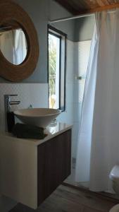 a bathroom with a sink and a mirror at Guest Tiny House - lake side in Montevideo