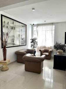 a large living room with couches and a table at Hotel Colonial Plaza in Bucaramanga