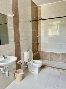 a bathroom with a toilet and a sink at Hotel Colonial Plaza in Bucaramanga