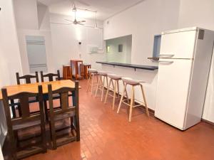 a kitchen with a refrigerator and a table and chairs at Río Plateado Hostel in Buenos Aires