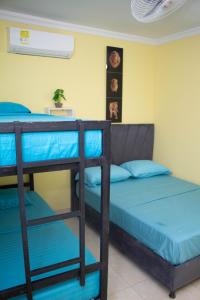 a room with two bunk beds in a room at Comfort House in Santa Marta