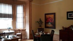 a dining room with a table and chairs and a window at Moonlight Manor in Victoria West