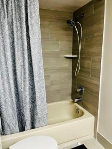 a bathroom with a shower with a tub and a toilet at Mandarin Cheerful 2 Bedroom Townhouse w/fireplace in Jacksonville