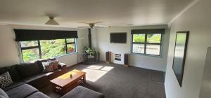 a living room with a couch and a table at Spa, Stay & Holiday in Rotorua